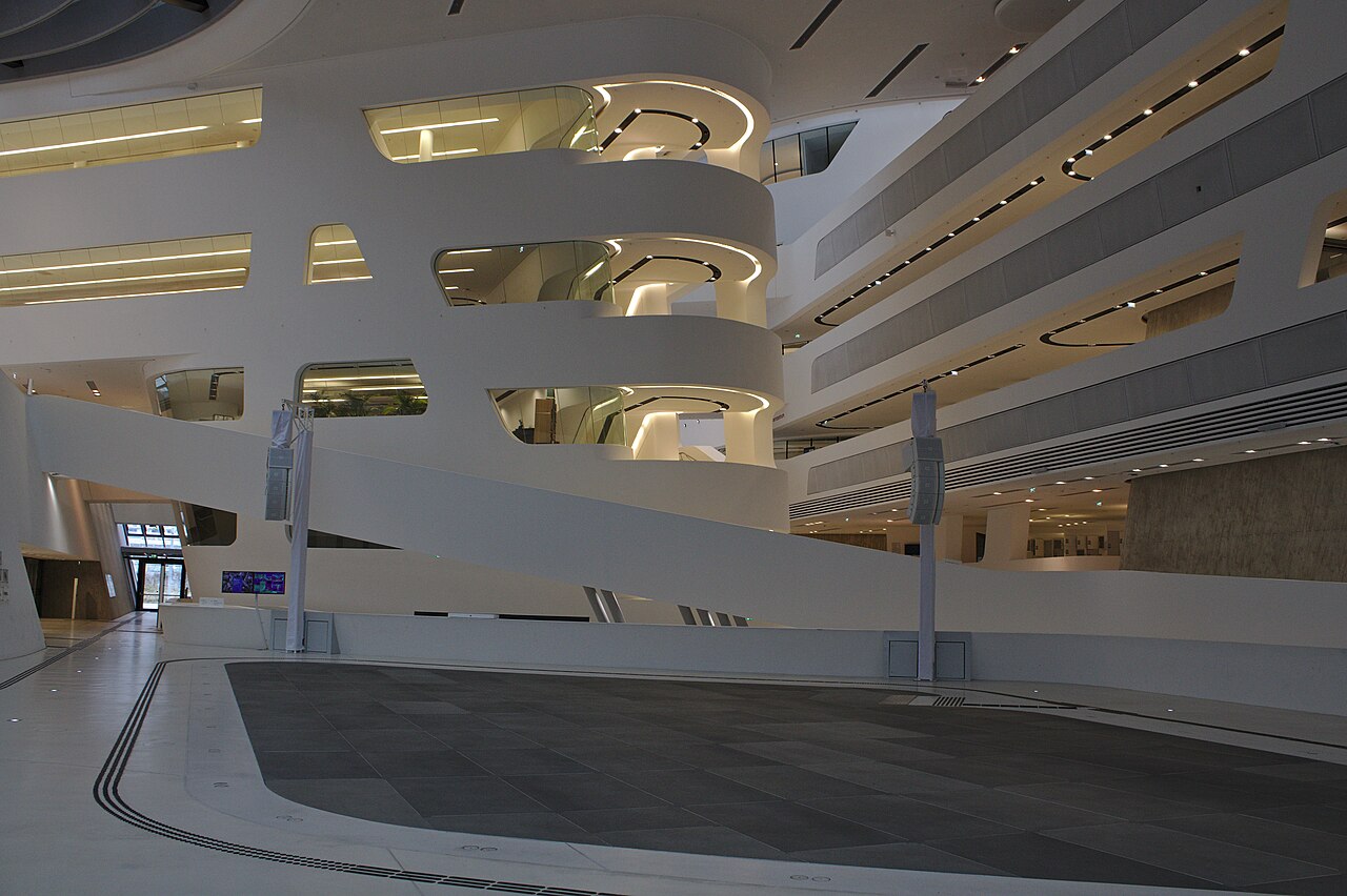 Inside the Library and Learning Center at WU Vienna, with its sweeping white walkways and angular architecture.